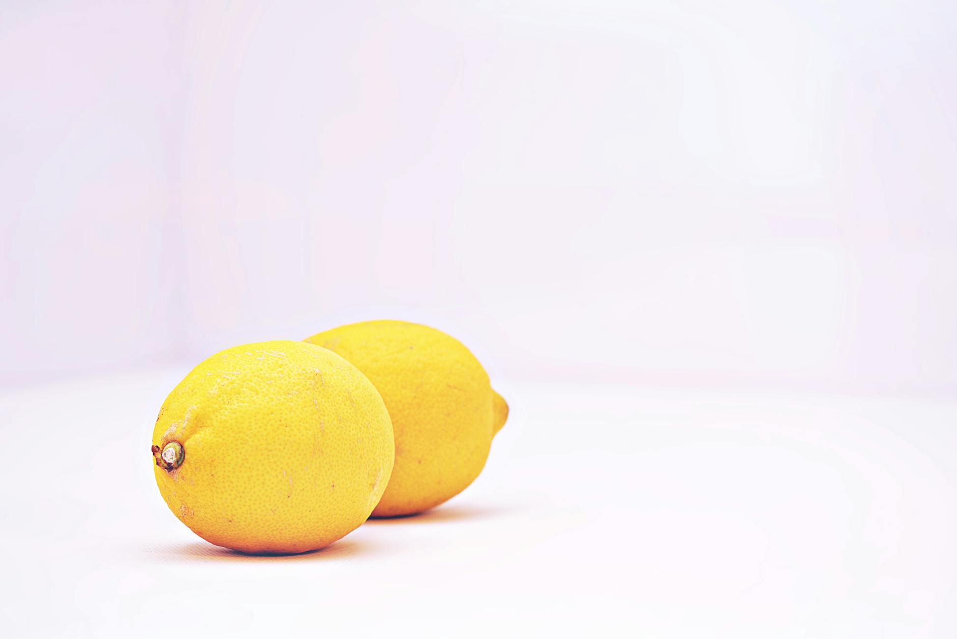 Two vibrant lemons on a white background, symbolizing freshness and vitality at any age