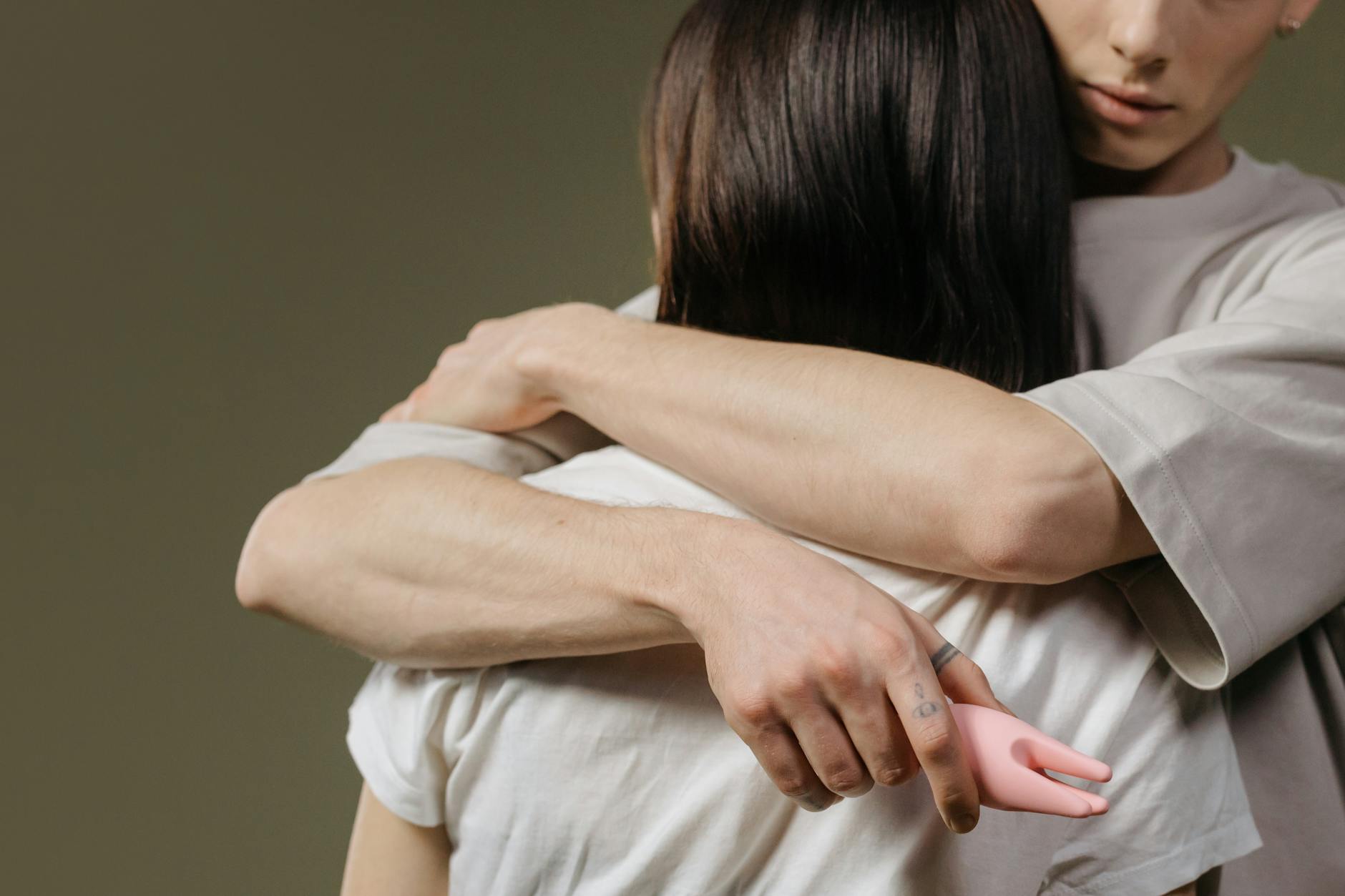 Close-up of a couple embracing in an intimate moment, showing comfort and connection.
